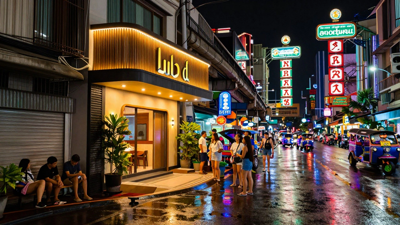 Neon-lit Sukhumvit street scene at night with modern hotel entrance and busy traffic
